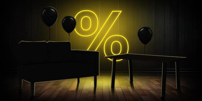 Canapea neagră și masă din lemn cu baloane negre în fața unui semn galben luminos de procent pe podea din lemn închis.